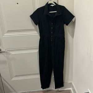 Carly Jean LA black jumpsuit. Stretchy fabric. Collar. Cuffed arms and pants.